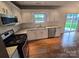 Kitchen with stainless steel appliances, gas range, granite counters, white cabinets and hardwood floors at 3912 Laurel View Cir, Indian Trail, NC 28079