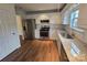 Bright kitchen with white cabinetry, stainless steel appliances, granite countertops, and hardwood flooring at 3912 Laurel View Cir, Indian Trail, NC 28079
