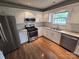 Well-appointed kitchen featuring stainless steel appliances, granite countertops, and hardwood flooring at 3912 Laurel View Cir, Indian Trail, NC 28079