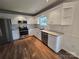 Updated kitchen featuring white cabinetry, stainless steel appliances, granite countertops, and hardwood floors at 3912 Laurel View Cir, Indian Trail, NC 28079