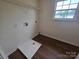 Laundry room featuring a storage shelf, a window, and hardwood flooring at 3912 Laurel View Cir, Indian Trail, NC 28079