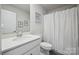 Clean, bright bathroom with a shower featuring framed art and single sink vanity with a white countertop at 4015 Havenport Cir, Fort Mill, SC 29708