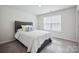 Comfortable bedroom featuring a large window and a sizable upholstered bed at 4015 Havenport Cir, Fort Mill, SC 29708