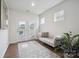 Bedroom sitting area with stylish chaise, natural light and access to backyard at 4015 Havenport Cir, Fort Mill, SC 29708