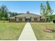 Exterior shot of a tan single-story clubhouse with a green lawn and inviting walkway at 4015 Havenport Cir, Fort Mill, SC 29708