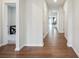 Inviting hallway with hardwood floors, white trim, leading to various rooms in the home at 4015 Havenport Cir, Fort Mill, SC 29708