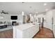 Bright, open kitchen with a large island, stainless steel appliances, and view to the living room and fireplace at 4015 Havenport Cir, Fort Mill, SC 29708