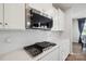 Modern kitchen features stainless steel appliances, white cabinets, white countertops and herringbone backsplash at 4015 Havenport Cir, Fort Mill, SC 29708