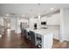 Open-concept kitchen with stainless steel appliances, a large island with bar seating, and sleek white cabinetry at 4015 Havenport Cir, Fort Mill, SC 29708