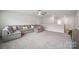 Spacious living area with plush carpeting, ceiling fan, and plenty of natural light at 4015 Havenport Cir, Fort Mill, SC 29708