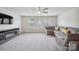 Bright living room with carpet, a sectional sofa, a ceiling fan, and three windows at 4015 Havenport Cir, Fort Mill, SC 29708