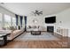 Bright living room with hardwood floors, two couches, a fireplace, and natural light streaming through large windows at 4015 Havenport Cir, Fort Mill, SC 29708