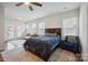 Comfortable main bedroom with a ceiling fan, natural light, and a stylish area rug at 4015 Havenport Cir, Fort Mill, SC 29708