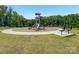Playground area with bench surrounded by trees and green grass at 4015 Havenport Cir, Fort Mill, SC 29708