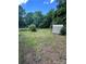 A spacious backyard featuring trees and a storage shed at 407 Lincoln St, Wadesboro, NC 28170