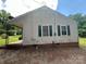This home has vinyl siding, green shutters, and a covered back porch at 407 Lincoln St, Wadesboro, NC 28170