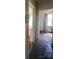 Hallway displaying weathered floors, open doorways, and natural light at 407 Lincoln St, Wadesboro, NC 28170