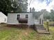 Back side of home with fuel tank, door, and stairs at 407 Lincoln St, Wadesboro, NC 28170