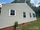 Exterior view of the home with vinyl siding and visible foundation at 407 Lincoln St, Wadesboro, NC 28170