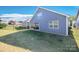 Well-maintained backyard with a view of the back of the house, landscaping and a black metal fence at 4245 Millstream Rd, Denver, NC 28037