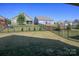Large backyard with lush green lawn and black metal fencing offers privacy and space for outdoor activities at 4245 Millstream Rd, Denver, NC 28037