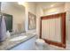 The bathroom features a granite countertop, modern sink, and shower with decorative curtain at 4245 Millstream Rd, Denver, NC 28037