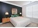 Cozy bedroom with dark accent wall, neutral walls, and great natural light at 4245 Millstream Rd, Denver, NC 28037