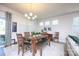 Dining area with a wooden table, seating for six, natural light, and access to the outdoor patio at 4245 Millstream Rd, Denver, NC 28037
