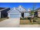 Charming blue home with a two-car garage, well-manicured lawn, and inviting curb appeal at 4245 Millstream Rd, Denver, NC 28037