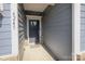 Inviting front entrance showcasing a stylish dark grey front door, coordinating sidelights, and modern house numbers at 4245 Millstream Rd, Denver, NC 28037