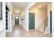 Inviting hallway with hardwood floors, paneled walls, and access to the staircase at 4245 Millstream Rd, Denver, NC 28037