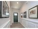 Elegant hallway featuring beautiful white wainscoting, fresh paint, and a view of the home's entrance at 4245 Millstream Rd, Denver, NC 28037
