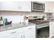 Bright kitchen featuring stainless appliances, granite countertops, and modern white cabinetry with silver hardware at 4245 Millstream Rd, Denver, NC 28037