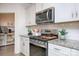 Stylish kitchen featuring stainless appliances, a gas range, granite counters, and ample white cabinetry at 4245 Millstream Rd, Denver, NC 28037