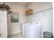 The laundry room features tile floors, new appliances, and shelving units for storage at 4245 Millstream Rd, Denver, NC 28037