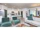 Open-concept living area with kitchen, island seating, and a comfortable living area with lots of light at 4245 Millstream Rd, Denver, NC 28037