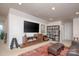 The living room features a TV, bookshelf, and stylish décor at 4245 Millstream Rd, Denver, NC 28037