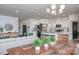 Open-concept living space featuring a modern chandelier, spacious layout, and seamless flow to the kitchen area at 4245 Millstream Rd, Denver, NC 28037