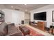 Spacious living room with a comfortable couch, TV, and stylish decor at 4245 Millstream Rd, Denver, NC 28037