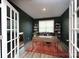 Office featuring dark accent walls, an area rug, and built in bookshelves at 4245 Millstream Rd, Denver, NC 28037