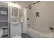 Stylish bathroom featuring a subway tile shower, vanity with sink, and built-in shelves for storage at 443 Brandon St, Davidson, NC 28036