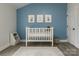 Adorable Bedroom with a blue accent wall, white crib, and charming decorations creating a cozy space at 443 Brandon St, Davidson, NC 28036