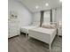 Bright bedroom featuring hardwood floors, two twin beds, and a dresser providing ample storage space at 443 Brandon St, Davidson, NC 28036