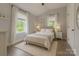 Inviting bedroom featuring a plush rug, neutral decor, and sunlit windows offering a serene atmosphere at 443 Brandon St, Davidson, NC 28036
