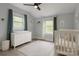 Charming Bedroom featuring a white crib, dresser, and windows with curtains, creating a calming environment at 443 Brandon St, Davidson, NC 28036