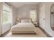 Cozy bedroom with neutral tones, featuring a comfortable bed, bedside tables with lamps, and natural light from two windows at 443 Brandon St, Davidson, NC 28036
