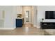 Hallway featuring light wood floors, a blue cabinet, and a view of a french door leading to another room at 443 Brandon St, Davidson, NC 28036