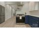 Kitchen featuring stainless steel appliances, white cabinets, and modern fixtures, creating an airy and efficient workspace at 443 Brandon St, Davidson, NC 28036