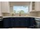 Bright kitchen featuring ample counter space, modern cabinetry, and fixtures, creating a functional and attractive cooking area at 443 Brandon St, Davidson, NC 28036