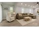 Bright living room featuring hardwood floors and neutral walls, complemented by a sectional and recessed lighting at 443 Brandon St, Davidson, NC 28036